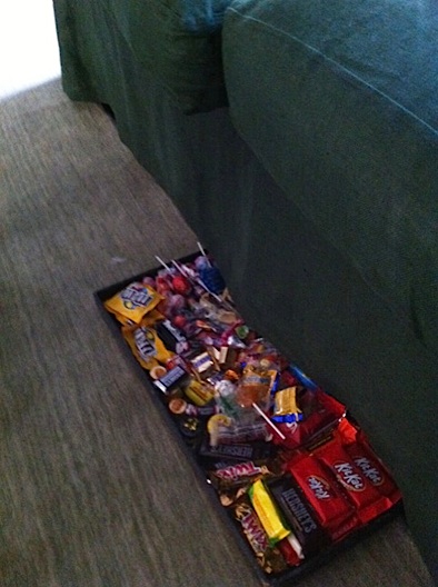 Halloween candy stash under the sofa