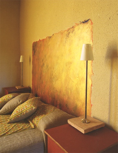headboard painted on wall in gold paint
