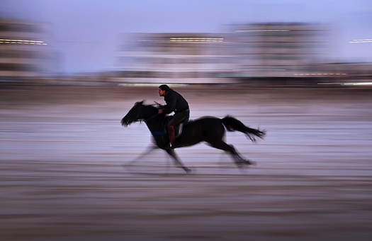 A Palestinian man rides a horse on the beach at sunset in the central Gaza strip on Jan. 11.